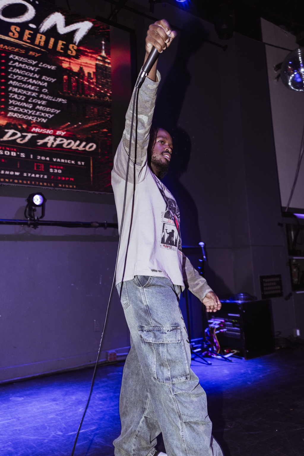 Young Moddy performing live with microphone raised